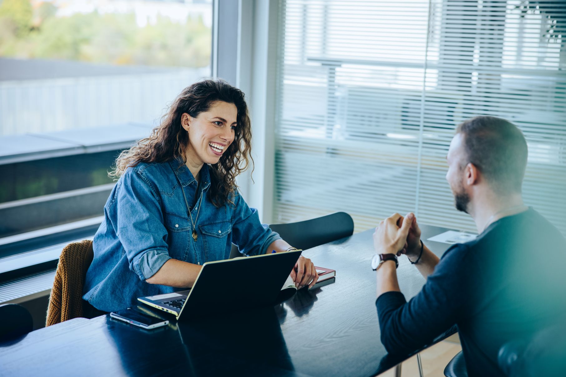 Smiling businesswoman taking interview of a job applicant
